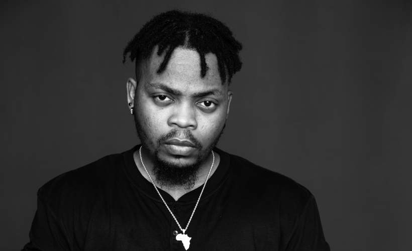 Olamide Adedeji, Nigerian celebrity rapper and one of the richest musicians in Nigeria, performing energetically on stage. Olamide net worth is $55 million.